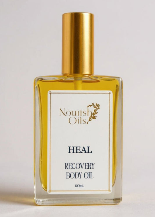 Bottle of Nourish Oils Heal Recovery Body Oil on a light background