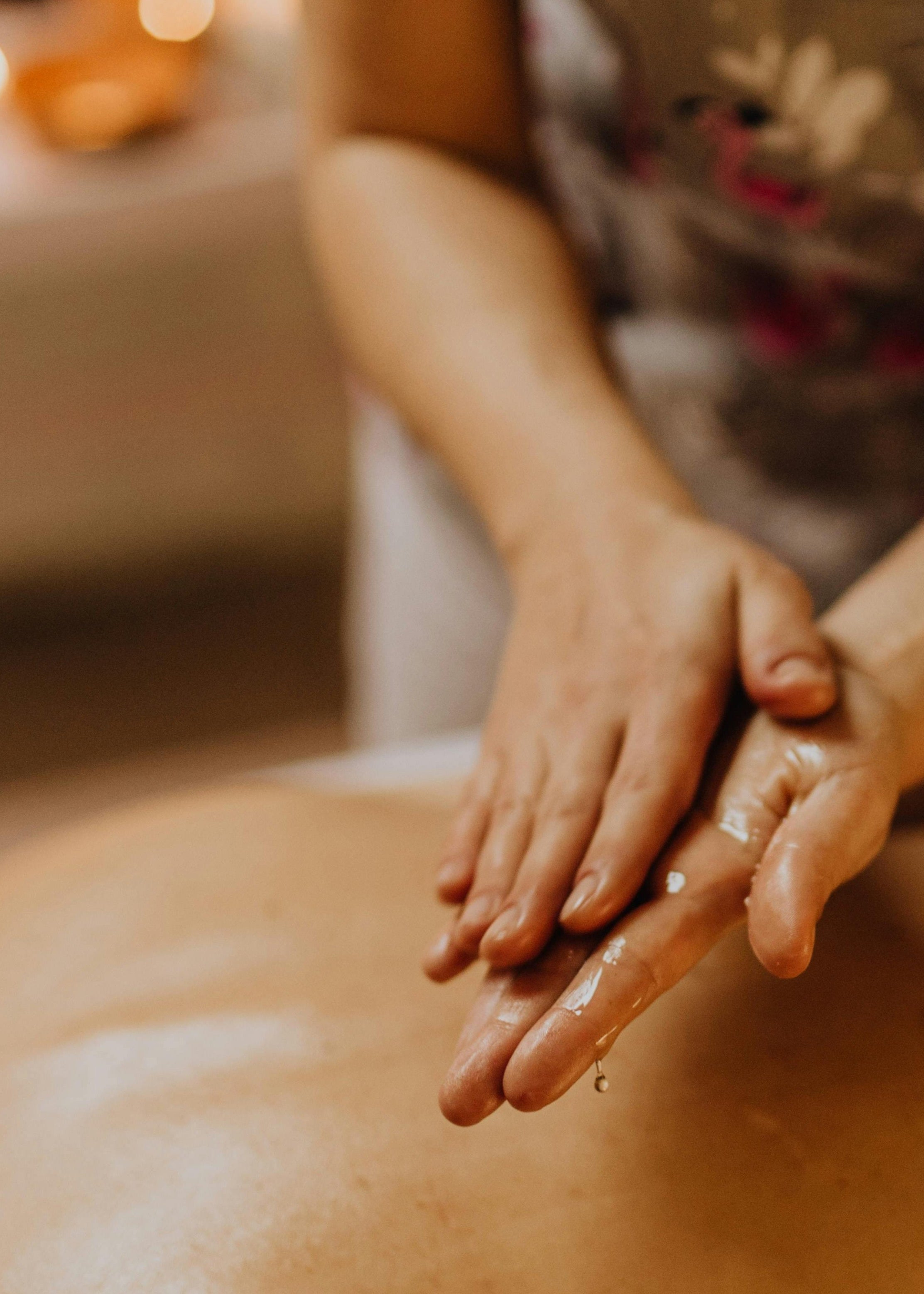 Person receiving a massage with hands on a blurred background