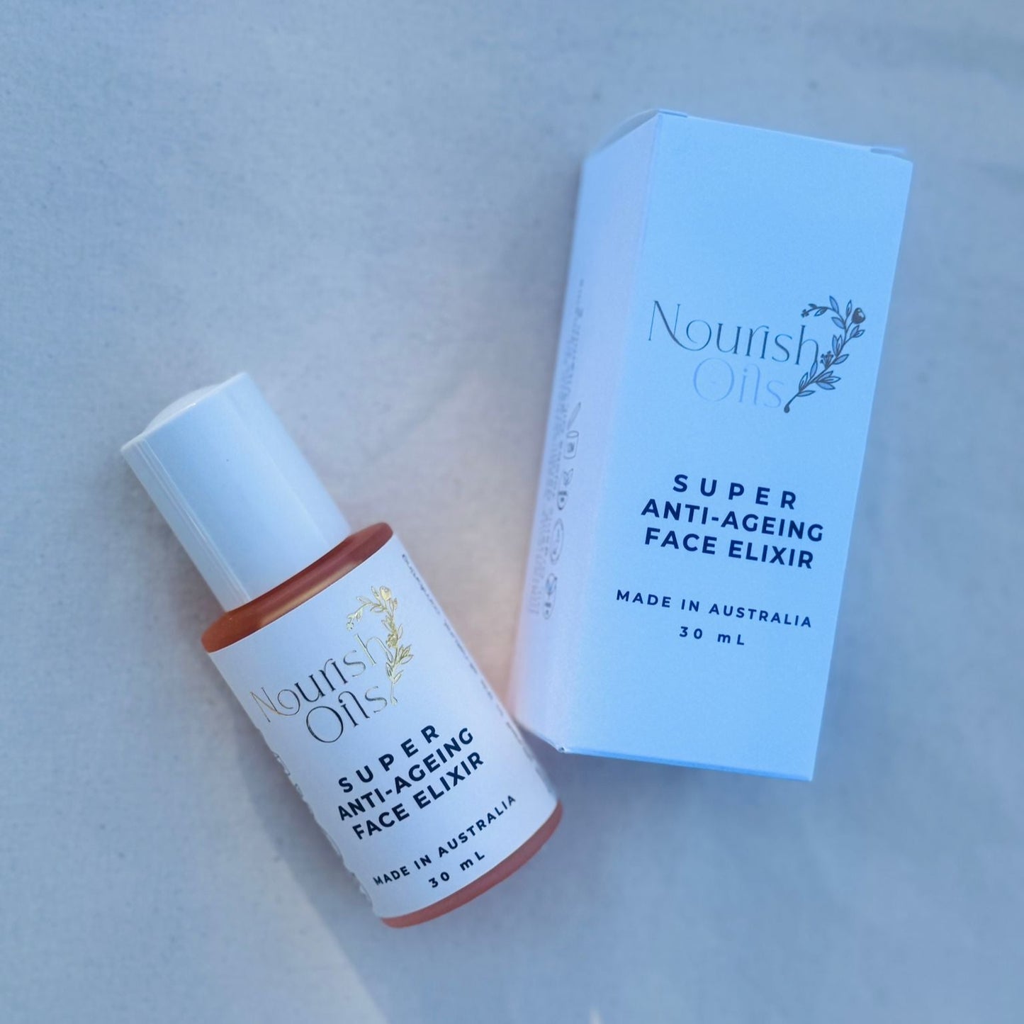 Super Anti-Ageing Face Elixir bottle and box on a light gray background