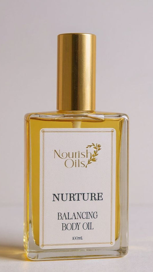 Bottle of Nourish Oils Nurture Balancing Body Oil on a light background
