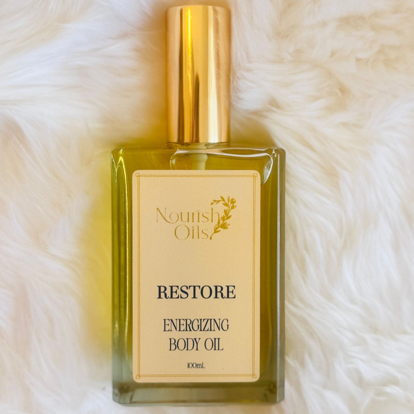 Clear golden drops of Restore Oil showing a lightweight texture designed for fast absorption and rejuvenation.