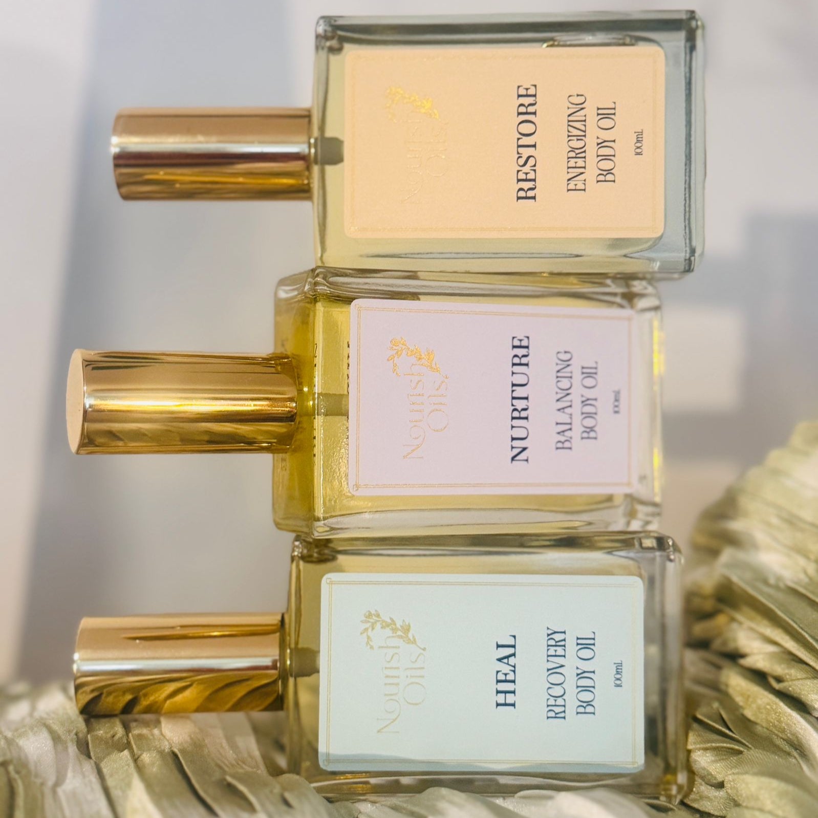 Heal Oil pictured alongside Nurtture and Restore Oils by Nourish Oils, a clean and natural wellness body care trio.