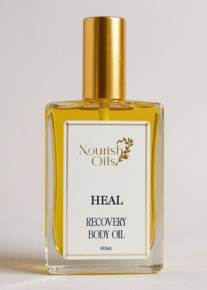 Bottle of Nourish Oils Heal Recovery Body Oil on a light background