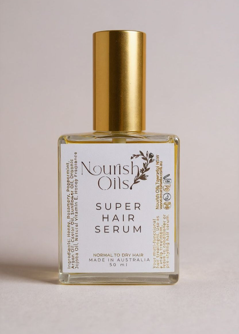 Bottle of Nourish Oils Super Hair Serum on a light pink background