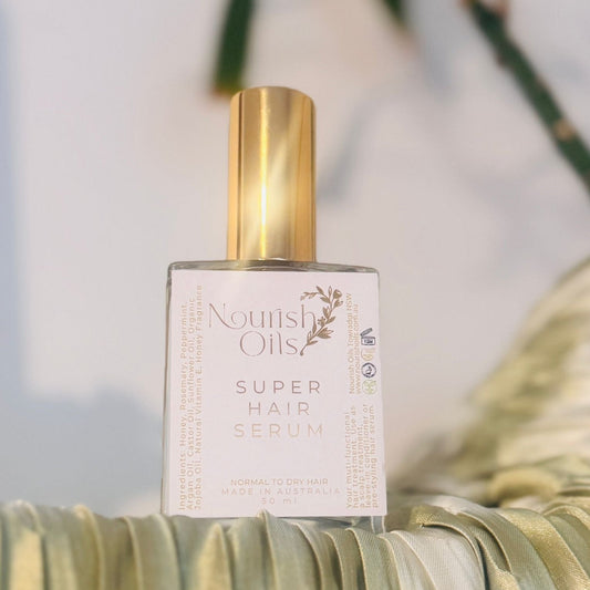 Nourish Super Hair Serum in a premium glass dropper bottle with gold cap, formulated with rosemary, argan oil