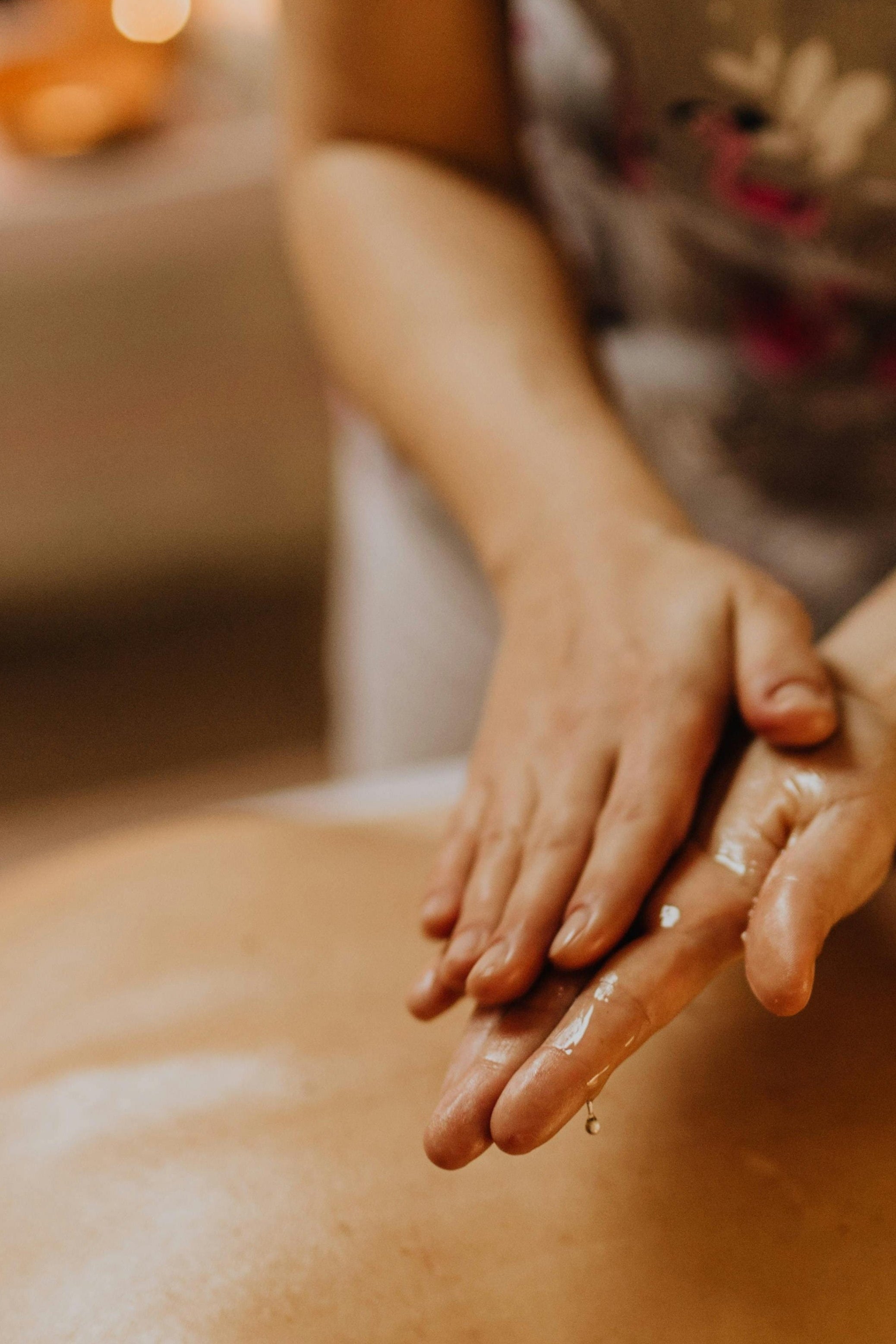 Person receiving a massage with hands on a blurred background