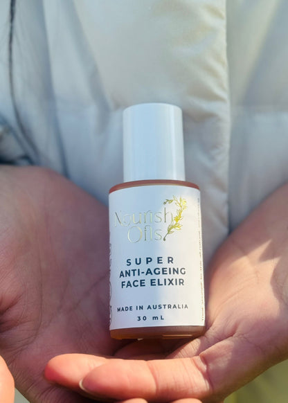 Bottle of 'Super Anti-Ageing Face Elixir' held in hands with a blurred background