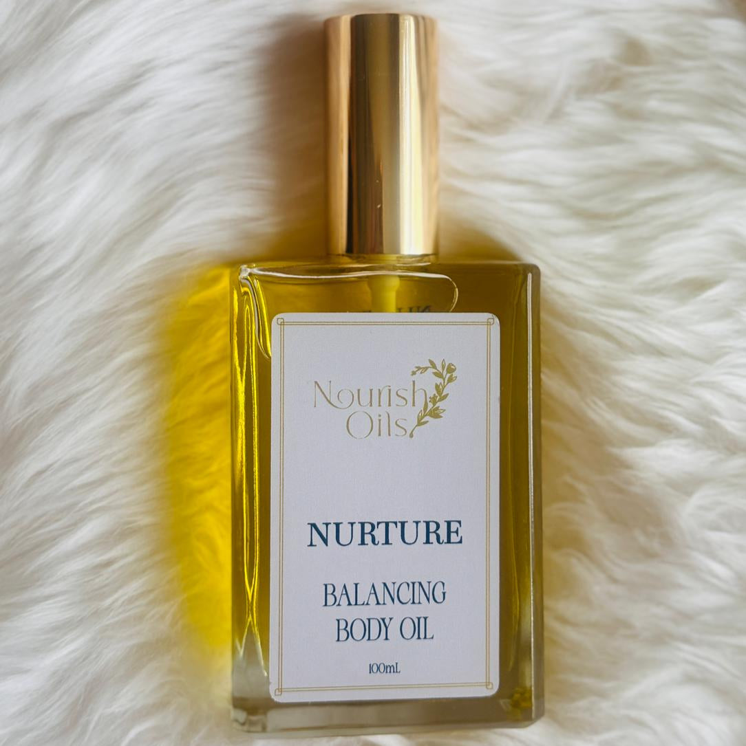 Nurture Body and Massage Oil by Nourish Oils natural balancing body oil in a luxe glass bottle with gold cap.
