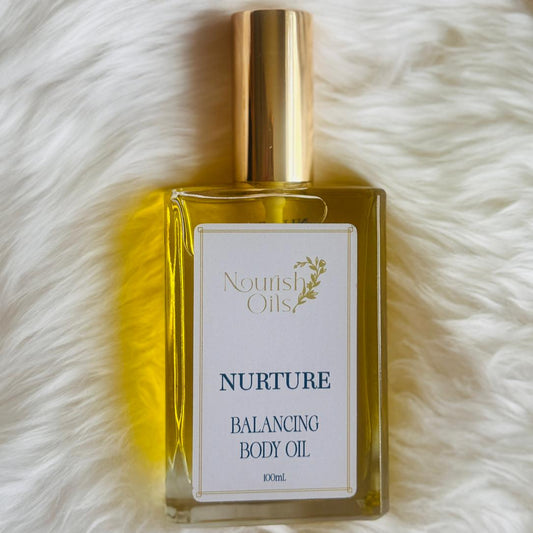 Nurture Body and Massage Oil by Nourish Oils natural balancing body oil in a luxe glass bottle with gold cap.
