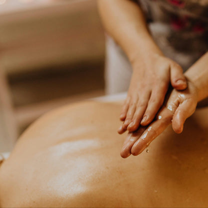Person receiving a massage with hands on a blurred background